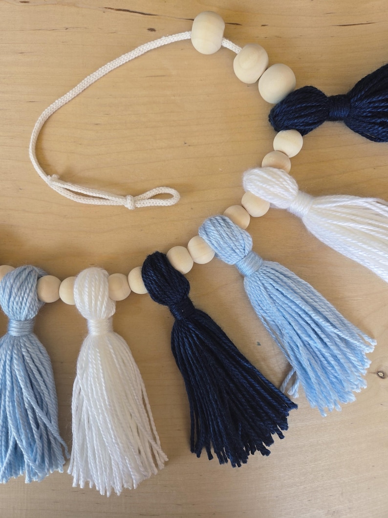 Handmade Carolina blue and white tassel garland for North Carolina college dorm and party decor, perfect for game days, tailgates, dorm rooms, and graduation celebrations