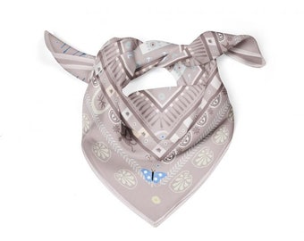May include: A gray bandana with a geometric pattern and a butterfly design. The bandana has a light brown background with white and blue accents.