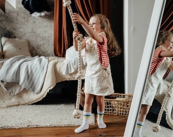 Pirate climbing rope for indoor kids space. This climbing rope can easily support the weight of any two adults. They can climb or swing.