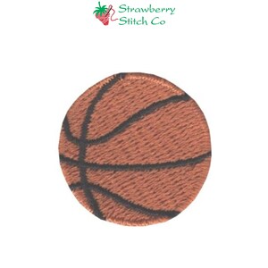 May include: A brown and black basketball with stitching detail. The basketball is round and has a textured surface.