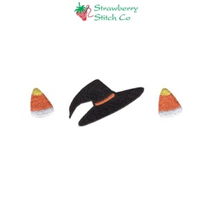 May include: Embroidered Halloween-themed design featuring a black witch hat with an orange band and two candy corn pieces. The design is set against a white background. The text "Strawberry Stitch Co" is in the upper right corner.