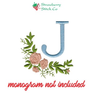 May include: Embroidered design featuring a light blue letter J with pink flowers and green leaves. The text "monogram not included" is at the bottom of the image.