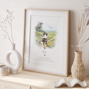 May include: A framed watercolour print of a dog walking on a path, set against a landscape. The dog is brown and white. The print includes the name "Benji" and a quote about friendship. The frame is light wood.