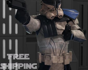 May include: A detailed image of a character in a white and blue armored suit, holding two black blasters. The helmet has a distinctive design, and the character is posed in a dynamic stance. The image is set against a gray background.