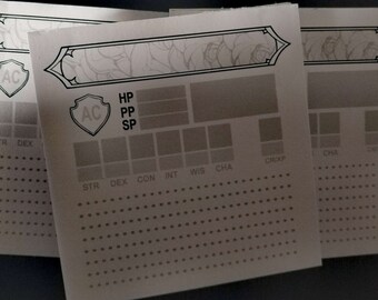 May include: A character sheet for a role-playing game, with sections for stats, hit points, and experience points. The sheet is printed on a light brown paper with a decorative border.