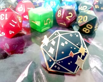 May include: A gold-colored metal pin shaped like a blue and black 20-sided die with gold stars and white accents. The die is a popular item for tabletop role-playing games.
