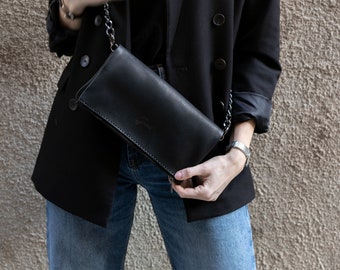 Bolso bandolera de piel negra cosido a mano: correa de cadena, estilo minimalista.