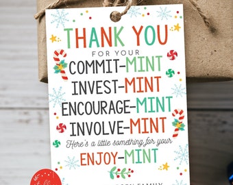 May include: A wrapped gift with a tag that reads "THANK YOU" with the words COMMIT-MINT, INVEST-MINT, ENCOURAGE-MINT, INVOLVE-MINT, and ENJOY-MINT. The tag has a festive design with snowflakes and candy canes. The gift is tied with twine.