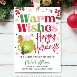 May include: A white Christmas gift tag with the words "Warm Wishes Happy Holidays" in red, green, and pink. A green mug with a gingerbread man and snowflake is shown. The tag includes contact information for a real estate agent.
