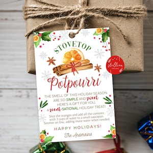 May include: A white printable gift tag with a red and green Christmas theme. The tag features a watercolour illustration of a stovetop potpourri with cinnamon sticks, star anise, and an orange slice. The text on the tag reads "Stovetop Potpourri" and includes instructions for making the potpourri. The tag is personalised with the text "The Andersons".