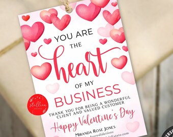 May include: A white card with a pink and red watercolor heart design. The text reads "You are the heart of my business. Thank you for being a wonderful client and valued customer. Happy Valentine's Day." The card also includes a business name, title, contact information, and the text "Personalize with Corjl."