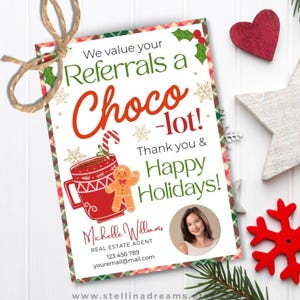 May include: A festive real estate referral card with the message "We value your Referrals a Choco-lot!" and a red mug with a gingerbread man. The card is decorated with a red heart, star, candy cane, and other holiday elements.