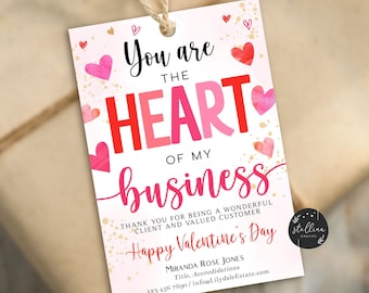 May include: A pink and red Valentine's Day card with the text "You are the HEART of my business". The card has a gold glitter background and pink and red hearts. The text "Thank you for being a wonderful client and valued customer. Happy Valentine's Day" is also on the card.