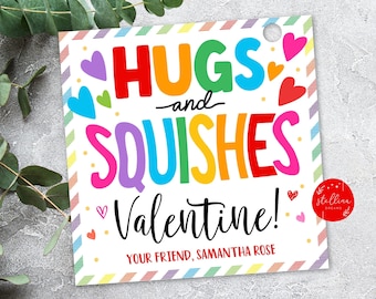 Pode incluir: Um cartão de Dia dos Namorados colorido com o texto "Hugs and Squishes Valentine!" e o nome "Samantha Rose". O cartão tem uma borda arco-íris e corações.