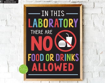 May include: A black chalkboard sign with a wooden frame, reading "In this laboratory there are no food or drinks allowed". The sign has a red circle with a line through it, depicting a hamburger and a cup with a straw. The text is in colorful letters.