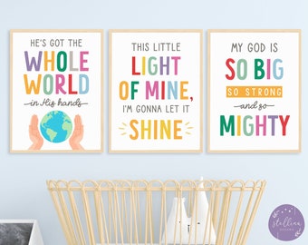 May include: Three colorful prints with inspirational quotes. The first print says "He's got the whole world in His hands" and features a globe with hands around it. The second print says "This little light of mine, I'm gonna let it shine". The third print says "My God is so big, so strong and so mighty".