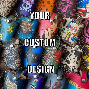 May include: A collection of colorful, custom designed leather pouches with various patterns and designs. The pouches feature a variety of themes, including animals, flowers, and abstract designs. The text "YOUR CUSTOM DESIGN" is superimposed on the image.
