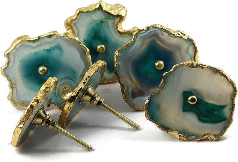 May include: Set of four agate drawer pulls with gold trim. Each pull features a unique green and white agate pattern with a gold screw.
