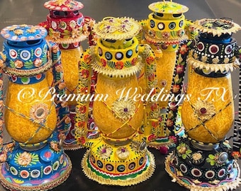 May include: Five decorative lanterns with intricate hand-painted designs. The lanterns are made of metal and have a yellow, blue, red, black, and green color scheme. The lanterns are decorated with flowers, geometric patterns, and mirrors. The lanterns are a popular decorative item for weddings and other special occasions.