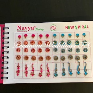 May include: A sheet of colorful, decorative bindi stickers for the forehead. The sheet includes a variety of designs, including round, floral, and spiral patterns. The stickers are available in pink, gold, and blue colors. The sheet is labeled "Navya Suhag Sticker Kumkum" and "New Spiral".