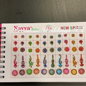 May include: A sheet of colorful, decorative, self-adhesive, temporary tattoos. The sheet is labeled "Navva™ Silk Weddings New Spiral FX". The tattoos are in various shapes and sizes, including circles, flowers, and swirls. The tattoos are in a variety of colors, including red, blue, green, yellow, and purple.