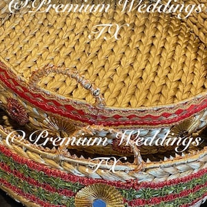 May include: Two round woven baskets with red and green trim. The top basket has a gold and silver trim. The bottom basket has a gold and silver trim with a small round mirror in the centre.