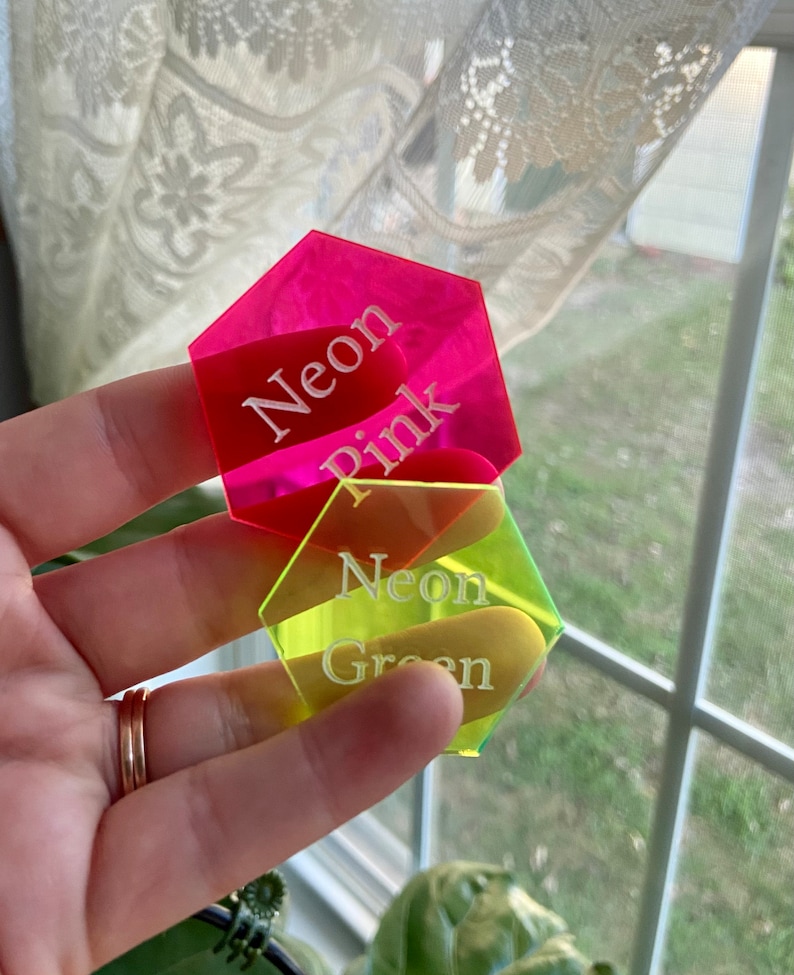 May include: Two hexagonal acrylic tags with white text. The top tag is neon pink and says "Neon Pink". The bottom tag is neon green and says "Neon Green".