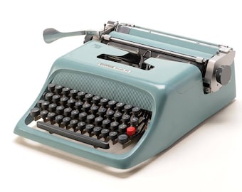 OLIVETTI STUDIO 44 original light blue in perfect working order - mint condition - restored - QWERTY layout is available - with case