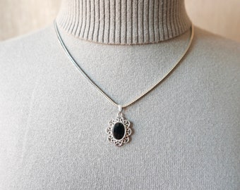 Vintage Sarah Coventry Silver Tone Pendant Hangs from a Monet Silver Tone Box Chain. Silver Tone Filigree Pendant with Black Onyx Center.