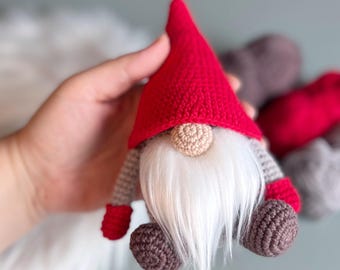 May include: A crocheted gnome with a red hat, white beard, and brown felt feet.