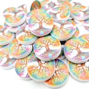 May include: A pile of round, colorful buttons with a tree of life design. The buttons feature a rainbow gradient background with a detailed tree illustration in the center. The buttons are white on the sides.