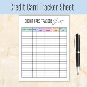 May include: A white paper credit card tracker sheet with a grid layout featuring columns for credit card name, date, line of credit, available credit, balance due, and payment amount due, accompanied by a black and silver ballpoint pen.