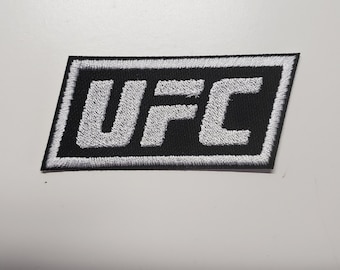 May include: White embroidered UFC logo patch on a black background with a white border.