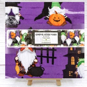 May include: Purple fabric with a Halloween gnome theme. The fabric features gnomes dressed in costumes, pumpkins, and a haunted house. The text "Gnome-ster Mash" is printed on the fabric.