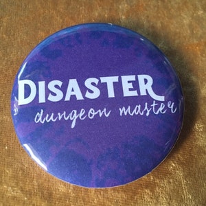May include: Purple button with white text that reads "DISASTER dungeon master".