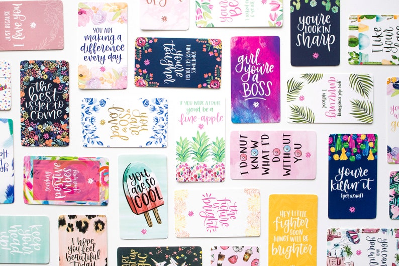 May include: A set of colorful affirmation cards with various inspirational messages, such as "You are so loved", "You are a boss", and "The best is yet to come".