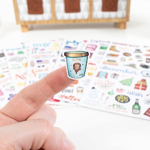 May include: A sticker of a blue and white ice cream container with the text "BLOOM" and "240 ml" on it. The sticker is part of a set of stickers with various designs.
