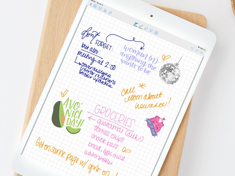 May include: A handwritten to-do list on a grid paper background. The list includes items like "don't forget", "meeting at 2:00", "cover design", "sticker updates", "woman (n) anything she wants to be", "call mom about insurance", "avo nice day", and "groceries: guacamole (duh!), tortilla chips, snack bars, bread, eggs, milk, water bottles".