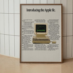 May include: A vintage advertisement for the Apple IIc computer. The ad features a beige Apple IIc computer with a green screen displaying a stock chart. The text highlights the computer's compact size, versatility, and high-resolution color graphics.