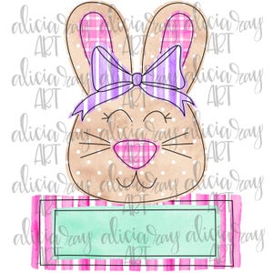 May include: A watercolor illustration of a bunny with pink and white checkered ears, a purple bow, and a pink nose. The bunny is holding a green banner with a white border.