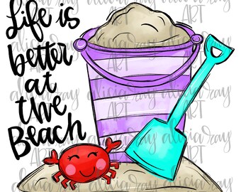 May include: A purple and white striped bucket with sand inside, a blue plastic shovel, and a red cartoon crab on a sandy beach. The text "Life is better at the beach" is written in black cursive.