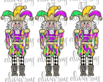 May include: Three nutcracker figurines with purple, green, and gold Mardi Gras themed costumes. The nutcrackers are standing with their arms at their sides and have a jester hat on their heads.