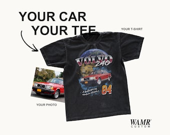 May include: A black short-sleeve t-shirt featuring a graphic print of a red Volvo 240 car with the text "VOLVO 240", "84", and "A Bulletproof Modern Classic". The image also includes the text "YOUR CAR YOUR TEE", "YOUR T-SHIRT", "YOUR PHOTO", and "WAMR CUSTOM".