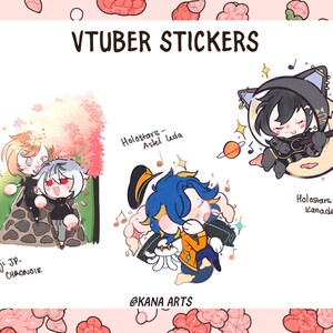 May include: A collection of colorful VTuber stickers featuring anime-style characters. The stickers include characters from Holostars and Nijisanji JP, with text labels identifying each character. The background is a light pink with floral patterns.