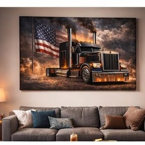 May include: A large canvas print depicts a semi-truck with an American flag in the background. The truck is black and silver with chrome accents, set against a dramatic, smoky sky. The artwork is displayed above a gray sofa with throw pillows.
