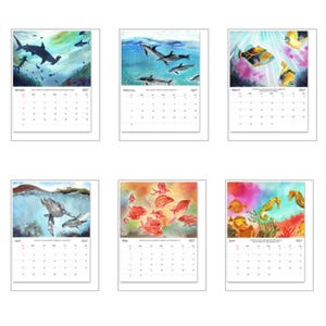May include: A 2027 wall calendar featuring six pages with watercolour illustrations of marine life, including sharks, dolphins, tropical fish, sea turtles, red fish, and seahorses, each paired with a monthly grid for January through June.
