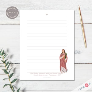 Close up of blank lined printable stationery page with Catholic saint in the bottom right corner and corresponding saint quote on the bottom of the page. A small cross is shown on the top of each paper. Printable PDF letter sized writing paper.