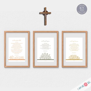 May include: Three printable wall art prints with a wood frame. Each print features a different colour floral design and text that reads "act of faith", "act of hope", and "act of love".