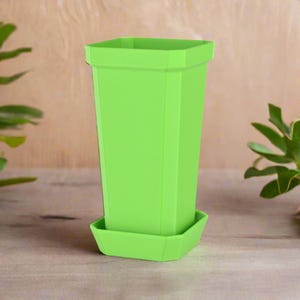 May include: A bright green plastic planter with a square shape and a matching saucer. The planter has a textured surface and is designed for indoor or outdoor use.