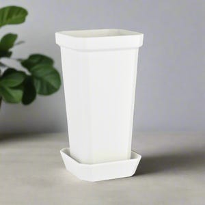 May include: A white plastic planter with a square base and a square top. The planter has a matching white saucer.